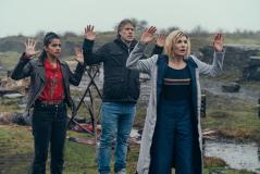 Yaz (MANDIP GILL), Dan (JOHN BISHOP), The Doctor (JODIE WHITTAKER) (Credit: James Pardon / BBC Studios)